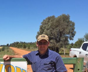 Phil at the front gate of his farm